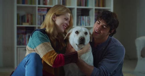 Young Couple Puts Pet Dog in Living Room