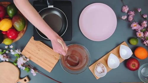 Chocolate Batter Being Poured in a Kitchen