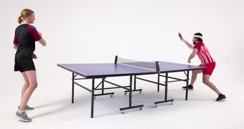 Playing table tennis, two people enjoying game in indoor setting