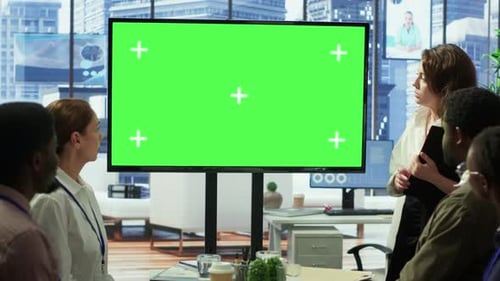 Diverse Group of Startup Employees Looking at Green Screen on Interactive Board