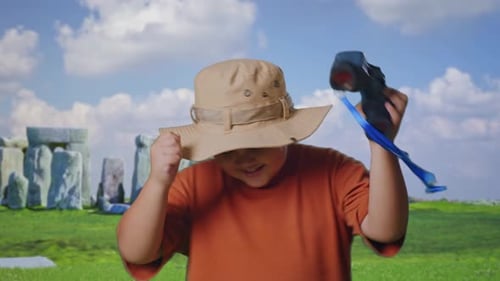 Asian Boy Dancing After Use The Binoculars In Stonehenge, Close Up