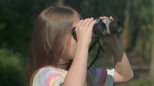Kid Girl with Binocular on Green Background Close Up Happy Child Scout Outdoors