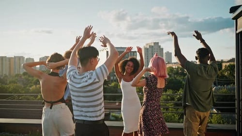 Group of Friends Dancing on a Rooftop Party