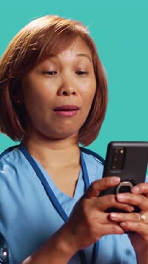 Clinic Employee Texting on Phone at Work