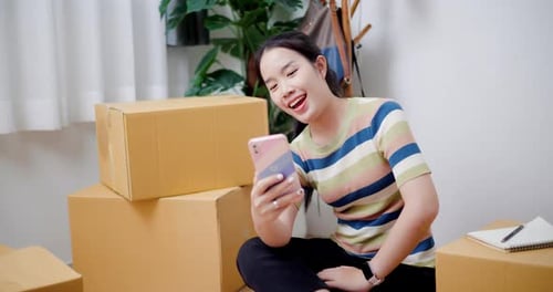 Young Woman Video Chatting Near Moving Boxes