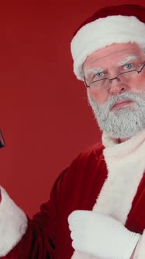 Santa Claus Holding an Alarm Clock on Red