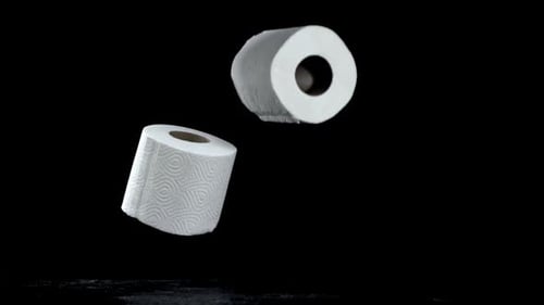 Rolls of White Toilet Paper Falling in Slow Motion