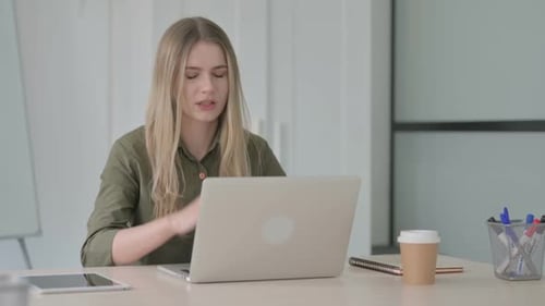 Blonde Woman with Headache Working at Laptop