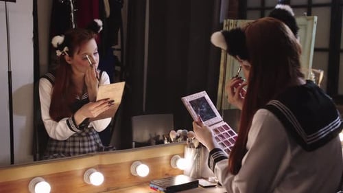 Young Woman Applying Makeup with Cat Ear Headband