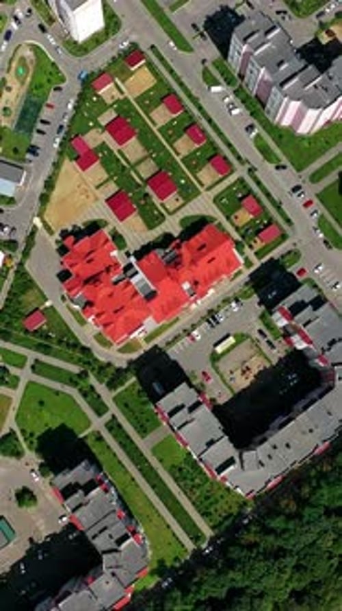 Drone view of city building block. Top down view of new modern block of flats in green area
