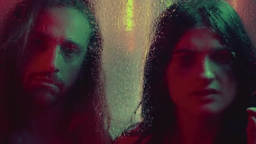 Sad Couple Posing Behind Wet Glass