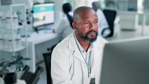 Man Working in Laboratory Looking at Computer