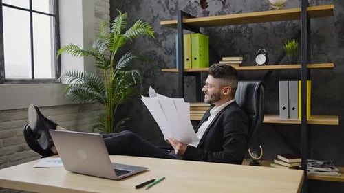 Excited Businessman Celebrating Success in Office