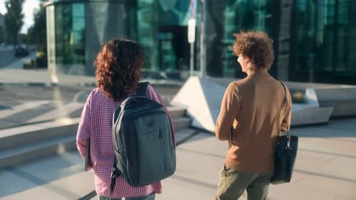 Rear View of College Friends Walking Casually on Modern University Campus