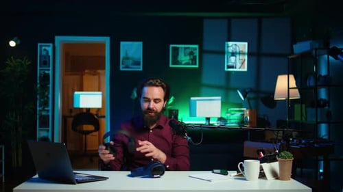 Man in Studio Talking Into Microphone With Headphones