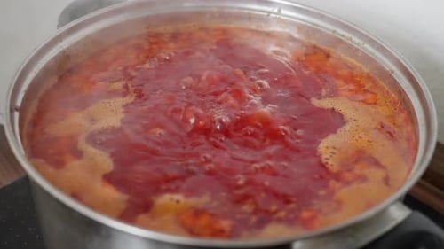 Delicious Red Soup Boiling in Silver Pot
