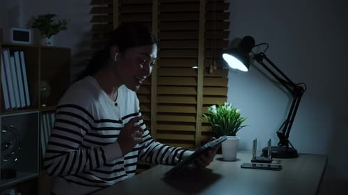 Woman Video Calling with Tablet at Night