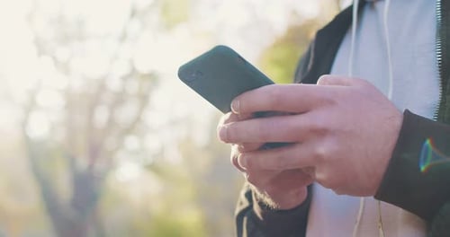 Close Up of Caucasian Man Texting Sms and Chatting on Smartphone Device Outdoor Male Hands Tapping