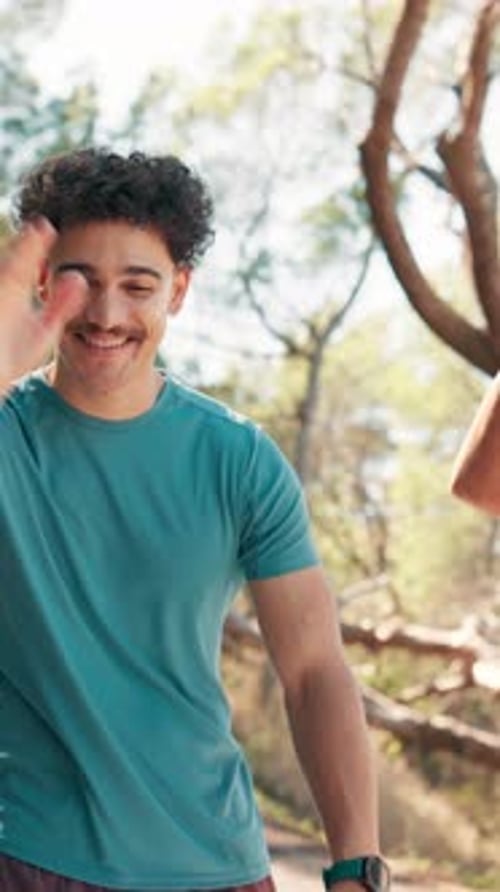 Man High Fiving Friend After Workout Outdoors