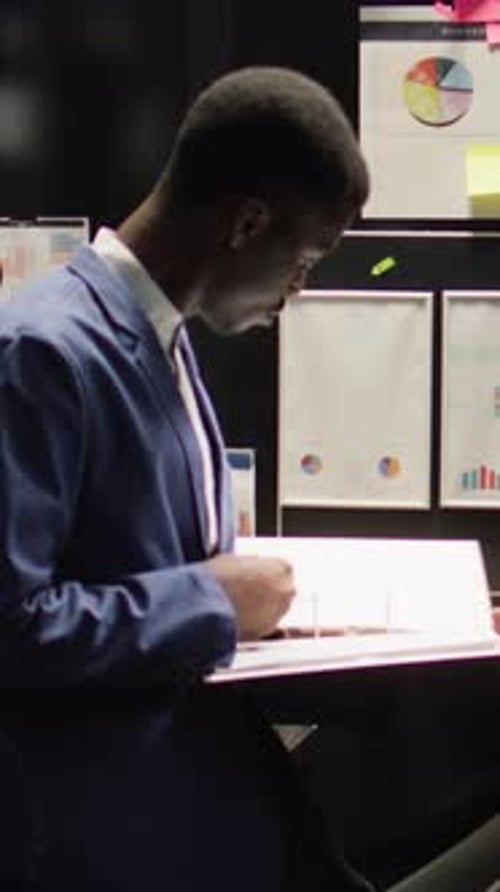 Smiling Young Professional at Work Analyzes Data