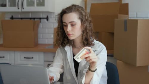 Woman Types Credit Card Details Making Payment on Website