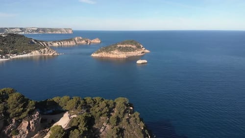 Cliffside with clear blue sea water. Drone shot of Spanish rocky coastline
