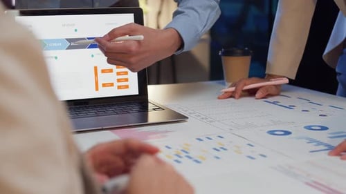 Closeup businesspeople meeting plan analysis statistics brainstorm at office night.