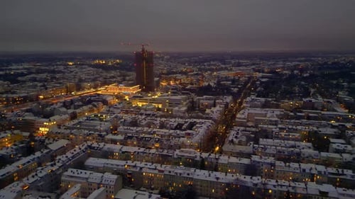 Berlin City lights, rooftops covering in snow winter at dusk. Wonderful aerial view drone
