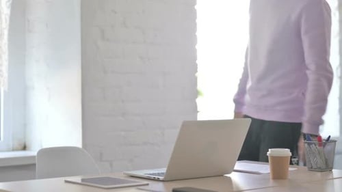 Man Starts Working at Desk on Laptop