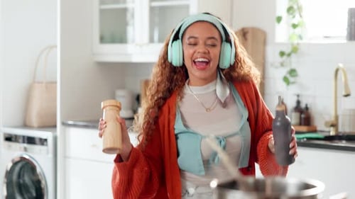 Woman Cooking and Dancing in Modern Kitchen