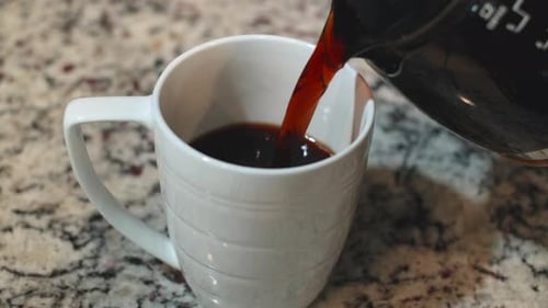 Close up shot of pouring fresh hot coffee and white milk in white cup im the morning