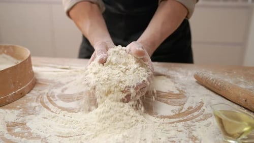 Cook Pours Out White Flour In Hands