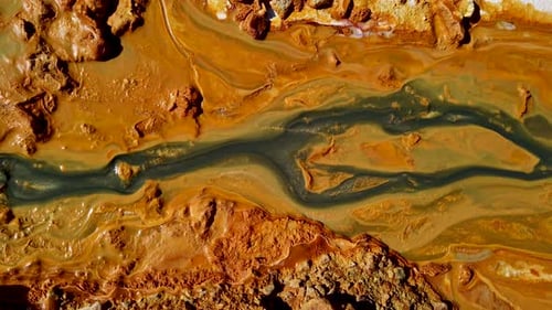 Acidic mine residual water drainage, flowing into decanting pond. Rosia Montana, Romania