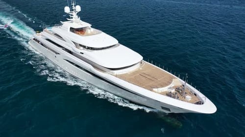 Luxury Yacht Sailing Across Ocean on Sunny Day