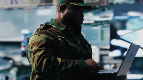 Adult Types on Laptop in High-Tech Office