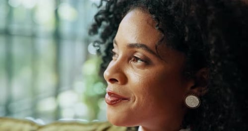 Woman with Curly Hair Looking Out Window