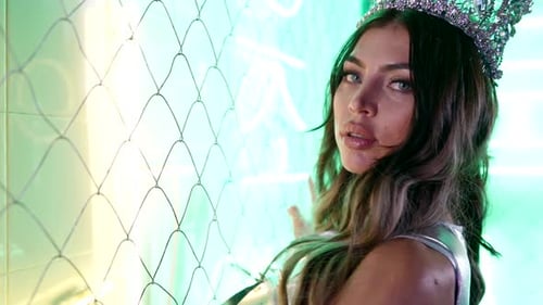 Woman with Crown Posing in Futuristic Neon Setting