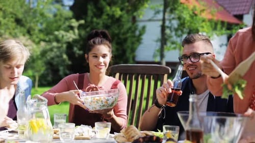Leisure, Holidays, Eating, People and Food Concept - Happy Friends Having Dinner
