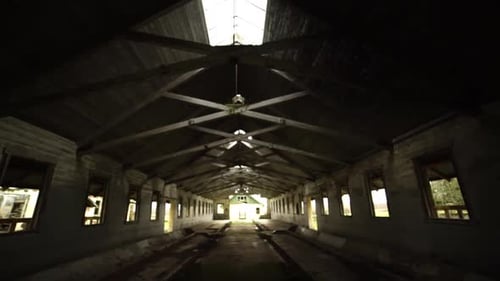 Interior pan from up of an abandonded barn and the roof rafters near an insane asylum, dark, creepy,