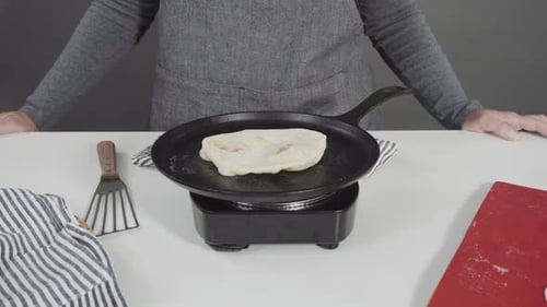 Preparing Homemade Flatbread on a Castiron Skillet