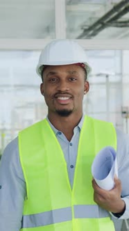 Handsome Smiling Confident Highskilled African American Contractor of Building Works Standing in the