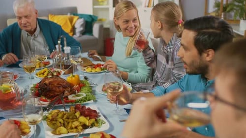 Multi-generational family enjoying meal together indoors at table
