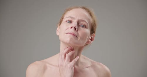 Middle Aged Woman Touching Her Face