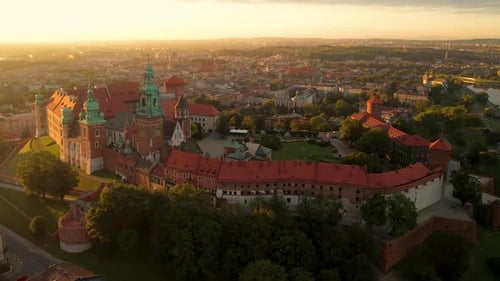 Aerial flyover view of a Wawel castle with Gardens and cathedral at summer sunrise, Cracow, Poland