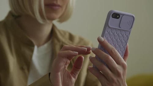 Woman Scrolling on Smartphone at Home