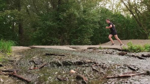Outdoor workout: man runs through the forest, energizing himself with fresh air and the sounds of na