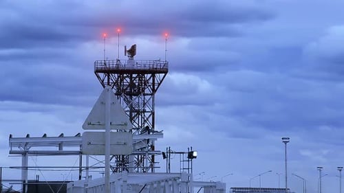Airport Radar Tower on Overcast Night Sky