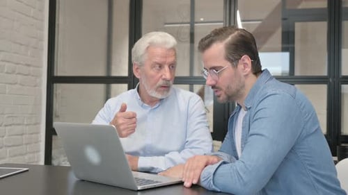 Men Working Together on Laptop in Modern Office