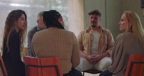 Adults in Group Therapy Session Sharing Experiences