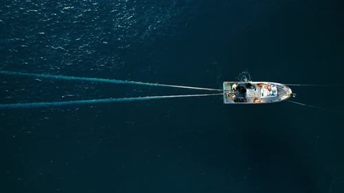 Fishermen in Small Boat Trawling Sardines and Sea Fish in Ocean
